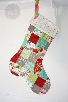 a quilted christmas stocking hanging from a hook