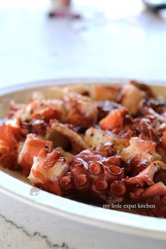 an octopus dish is served in a bowl