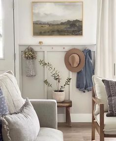 a living room filled with furniture and a painting on the wall