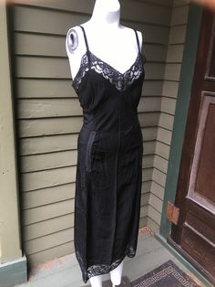 "1940's 3-piece ensemble. Black lace full slip and black sheer patterned top and matching skirt. Top has white lace details and brown celluloid buttons. Semi sheer in places, as it has a burn out lace pattern Good condition, dime-sized hole in fabric near left armpit. Size medium/large Button up blouse: 42\" bust 24\" shoulder to hem Full black slip - nylon and acetate 40\" bust 34\" waist 44\" shoulder to hem Skirt: 36\" waist 44\" hips 28\" waist to hem" Burn Out, Hem Skirt, Button Up Blouse, Large Buttons, Black Slip Ons, Lace Pattern, Top Pattern, Skirt Top, Lace Detail