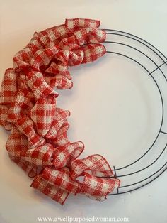 a red and white checkered scrunffle on a wire wreath