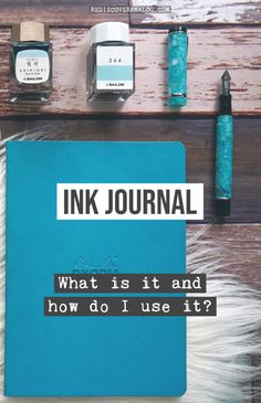 an ink journal sitting on top of a wooden table next to some pens and ink