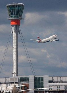 an airplane is taking off from the airport with another plane in the air behind it