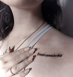 a woman with her hand on her chest has a tattoo that says future's sona be okay