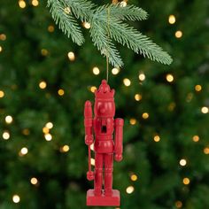 a red ornament hanging from a christmas tree