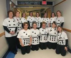 a group of women in white shirts and black pants