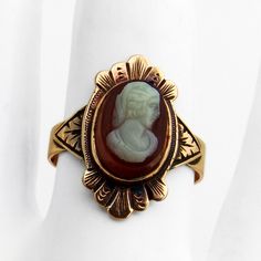 Antique Victorian 10 K (.417) rose gold ring, having ornate front with an oval form shell cameo inset, featuring carved female profile. This intricate ring is a size 7 3/4 and weighs 3.2 grams. Eb8934 Vintage Oval Cameo Ring, Victorian Oval Engraved Carved Ring, Victorian Oval Carved Rings, Victorian Style Oval Engraved Ring, Vintage Oval Carved Engraved Ring, Art Nouveau Oval Cameo Jewelry, Gold Oval Cameo Signet Ring, Heirloom Oval Cameo Signet Ring, Gold Oval Cameo Rings