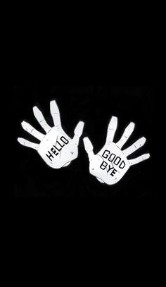 two white hands with words on them that say hello, goodbye and bye against a black background