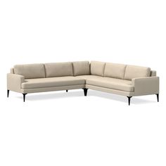 a beige sectional couch sitting on top of a white floor