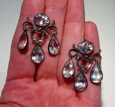 Antique GEORGIAN 14K and Sterling Silver ROCK CRYSTAL GIRANDOLE Pierced Chandelier Riviere Earrings. They measure 1 1/2” long by just over 1” wide and weigh 8 grams. Large 10mm x 8mm faceted oval rock crystal at the top and three dangling pear cut 12mm x 8mm rock crystal stones. 23 TCW. The ear Unusual Vintage Jewelry, Summer Wedding Jewelry, Diamond Cluster Earrings, Sterling Silver Cat, Crystal Stones, Gemstone Studs, Vintage Jewels, Oxidized Sterling Silver, Rock Crystal