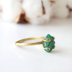 Dark green and gold create an emerald ring that sings with elegance and stands for bravery. The adjustable ring easily fits various ring sizes. The 14k gold filled metal setting creates a long-lasting and hypoallergenic ring. Each handmade pair uses a three step adhering process to guarantee durability and quality, Hypoallergenic material guarantees no reaction when you wear them. As no raw stone is the same, each emerald ring has a slightly different shape and size guaranteeing uniqueness and i Green Stackable Rings For Weddings, Adjustable Green Stackable Rings For Wedding, Green Emerald Open Ring Stackable Rings, Green Emerald Stackable Open Rings, Minimalist Adjustable Emerald Jewelry, Adjustable Green Emerald Ring For Wedding, Green Open Ring Stackable Rings For May Birthstone, Green Stackable Open Rings For May Birthstone, Adjustable Stackable Emerald Rings