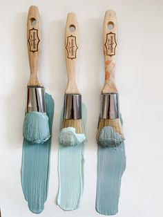 three paint brushes with different shades of blue