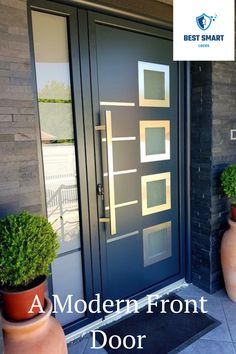 two potted plants are sitting on the front porch next to a blue door and black brick wall