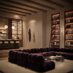 a living room filled with purple couches and bookshelves next to each other