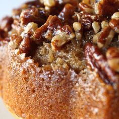 a close up of a cake with nuts on top