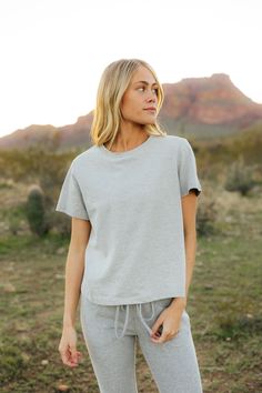 THIS SALE ITEM IS FINAL SALE! The Kellie Set-Heather Grey is the perfect combination of comfort and style! This set includes a relaxed fit short sleeve top and elastic waist jogger-style sweatpants, both in a cozy heather grey. Stay comfy and fashionable all day long! *Relaxed fit* Material Content: 100% Cotton // Bottoms: 65% Cotton // 35% Polyester Material Pattern: Heather Avery is 5'6" and wearing a small Model Measurements: Avery: Height: 5'6" // Chest: 31” // Waist: 24" // Hips: 31" Not su Short Sleeve Tops With Elastic Waistband For Loungewear, Athleisure Solid Top With Elastic Waistband, Athleisure Top With Elastic Waistband, Solid Color Athleisure Top With Elastic Waistband, Solid Athleisure Top With Elastic Waistband, Everyday Relaxed Fit Top With Elastic Waistband, Casual Tops With Elastic Waistband, Casual Loungewear Tops With Elastic Waistband, Athleisure Top With Elastic Waistband And Short Sleeves