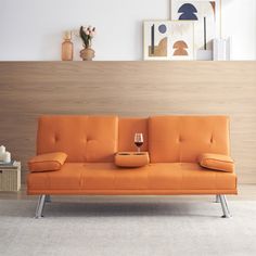 an orange couch with a glass of wine on it