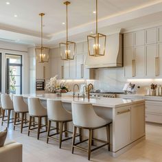 a kitchen filled with lots of counter top space and white chairs next to an oven