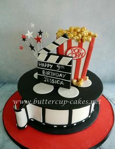 a birthday cake decorated with popcorn and movie claps