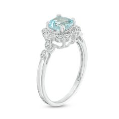 With touches of old and new, this vintage-inspired engagement ring captures her romantic style. Crafted in sterling silver, this lovely look showcases a 6.0mm cushion-cut lab-created icy-blue aquamarine wrapped in a frame of marquise and kite shapes adorned with sparkling diamonds and intricate milgrain detailing. Additional marquise shapes shimmer with petite diamonds and milgrain borders along the shank to complete this heirloom design. Captivating with 1/20 ct. t.w. of diamonds and a bright p Elegant Blue Topaz Halo Ring For Wedding, Classic White Gold Diamond Ring With Blue Topaz, Delicate Formal Ring With Center Stone, Delicate Diamond Accented Rings For Formal Events, Delicate Diamond Accented Rings For Formal Occasions, Delicate Rings With Center Stone For Formal Occasions, Delicate Rings With Diamond Accents For Formal Events, Elegant Blue Topaz Rings For Anniversary, Delicate Rings With Diamond Accents For Formal Occasions