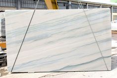 a large white marble slab in front of a building