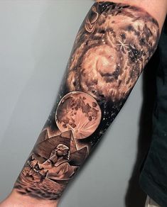 a man's arm with an image of two people on the moon and stars