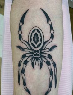 a black and white crab tattoo on the arm