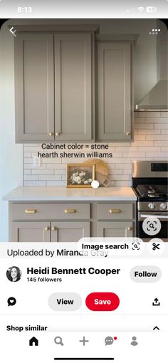 a kitchen with gray cabinets and white tile backsplash, an app on the phone