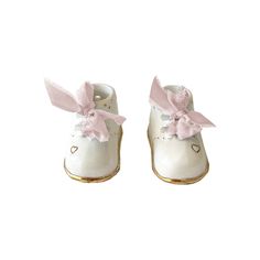 Description Celebrate the joyous arrival of a precious newborn with our exquisitely crafted ceramic baby booties. Each pair is delicately cast and carefully glazed to mimic the adorable shape of traditional baby shoes, & adorned with 22K gold details by skilled Ruby Clay artisans. These make for a thoughtful gift and precious addition to a nursery. With customizable options available, including name, birthdate and size, you can create a truly one-of-a-kind memento that will be treasured for a li Cute Soft Sole Booties As Gift, Pink Booties With Soft Sole For Gift, Pink Booties With Soft Sole As Gift, Handmade Round Toe Booties Gift, Cute Pink Booties For Gift, Handmade Round Toe Booties As Gift, Cute Pink Booties As Gift, Pink Booties With Round Toe As Gift, Pink Round Toe Booties As Gift