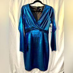 Turns Heads At Your Next Big Outing With This Electric Metallic Blue Mini Dress From Guess! Brand New With Tags From Macy’s Still Attached, Snag A Deal On This Unique And Vibrant Party-Ready Piece! Size 6, With A Stretchy Material That Leaves Room For Curves! :) Flattering Crisscross Details Under Chest/Around Waist V-Neck That Flatters Any Chest Size! Blue V-neck Holiday Mini Dress, Blue Bodycon Dress For Cocktail Party, Blue Bodycon Dress For Date Night And Party, Blue Dressy Party Dress, Spring Blue Bodycon Party Dress, Blue Bodycon Dress For Spring Party, Spring Party Blue Bodycon Dress, Blue Long Sleeve Mini Dress For Holiday, Blue Summer Dress For Holiday Party