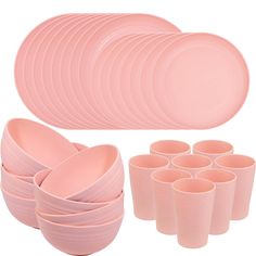 a set of pink dishes and cups on a white background, including one large plate with six smaller plates next to it