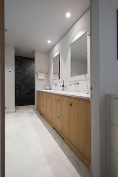 a large bathroom with two sinks and mirrors