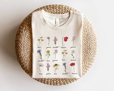 "Wildflower Shirt, Botanical Shirt, Womens Wildflowers Graphic Tshirt, Boho Botanical Chart T-shirt, Botany Floral Gift, Nature Lover Shirt ⭐Please Check All Photos For Details.   🐞Choose Your T-Shirt Size From The Drop-Down Lists Next To The item Picture   ⭐Choose Of Your T-Shirt Color From The 2nd Picture   🐞Use \"Add message to Seller\" link On The Checkout Page To Send me the Following important Details For Your Order's Customization.   ⭐Shipping Time Varies by location (we are located in Sugar Land, Texas) please consider that our turn around time is 1 to 3 business days. ⭐Which brand do you use for t-shirts? We use Gildan Soft Style, Bella Canvas Unisex, Rustic United,  Hanes, District and Next Level when we have a shortage of stocks for certain colors and sizes. Our printing metho Wildflower Shirt, Botanical Shirt, Botanical Illustrations, Floral Gifts, Botany, Cute Shirts, Nature Lover, Types Of Shirts, Peace And Love