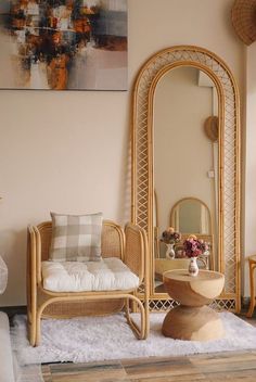 a living room with wicker furniture and mirrors on the wall, including a chair