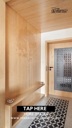 an entry way with wood paneling and black and white tile