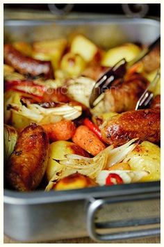 a pan filled with sausages, potatoes and onions