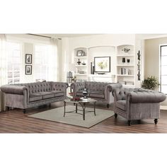 a living room filled with furniture on top of a hard wood floor