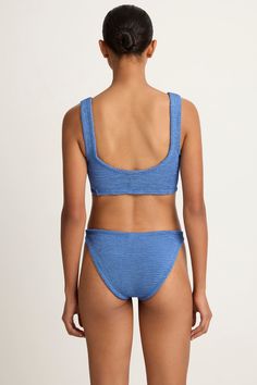 The Juno bikini features Hunza G's signature crinkle stretch fabric. Twist front detail with wide straps for support. Classic coverage bottom can be worn high or low on hip. Top & bottom sold as a set. Blue Textured Stretch Swimwear, Metallic Denim, Hunza G, Swimsuit Fabric, Crinkle Fabric, Twist Front, Juno, Wide Straps, Denim Fabric