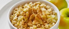 a white bowl filled with macaroni and cheese next to some green pears