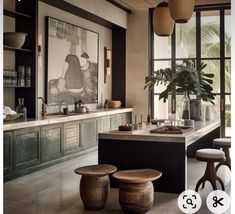 a kitchen with two stools in front of the counter and an art work on the wall