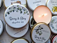 wedding favors and candles are arranged on the table