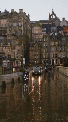 cars are parked on the street in the rain