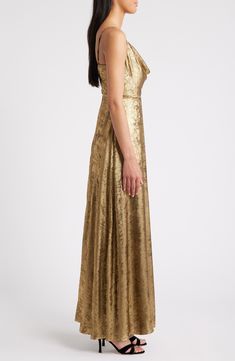 Stun the crowd in this mesmerizing metallic dress that has a gracefully draped cowl neckline for added allure. Hidden back-zip closure Cowl neck Front slit 100% polyester Dry clean Imported Gold Drapes, Metallic Gold Dress, Gold Cocktail Dress, Cowl Neck Dress, Dress Home, Cowl Neckline, Satin Midi Dress, Metallic Dress, Silver Dress