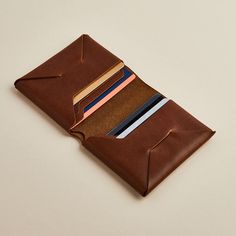 Carefully constructed minimalist wallet for men in black or brown leather, personalised with initials. Handmade in the UK. A men's leather wallet inspired by origami construction, containing all the essential features of a traditional bifold wallet: six staggered card slots and a large compartment for notes and receipts - ideal. One of our original Man & Bear products first created back in 2014, it's developed from a series of prototypes as we worked to perfect a design that has the sleek and se Modern Brown Trifold Wallet With Smooth Grain, Modern Brown Trifold Wallet, Modern Brown Rectangular Trifold Wallet, Minimalist Leather Trifold Wallet With Card Slots, Minimalist Leather Trifold Wallet With Interior Card Slots, Minimalist Leather Trifold Wallet, Modern Brown Card Holder For Gift, Modern Brown Card Holder As Gift, Modern Brown Card Holder Gift