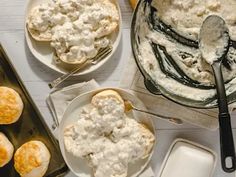 an assortment of desserts and pastries are on the table with utensils