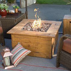 a fire pit sitting on top of a wooden table