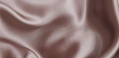 a close up view of a satin fabric with very soft folds and smooth lines on it