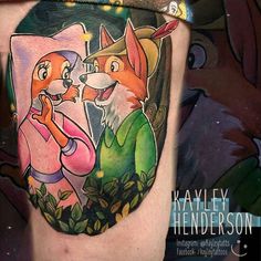 an artistic tattoo with two foxes on the thigh