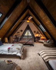 an attic bedroom with two beds and a loft