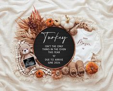 a baby's first thanksgiving outfit surrounded by pumpkins, leaves and other items